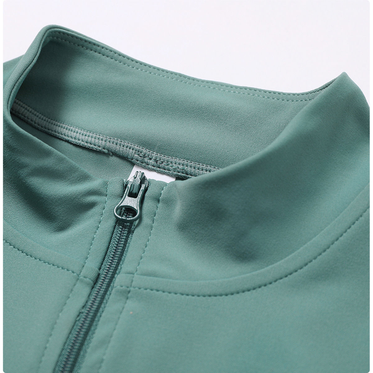Sports jacket zipper and collar seam detail for OEM sportswear manufacturer review