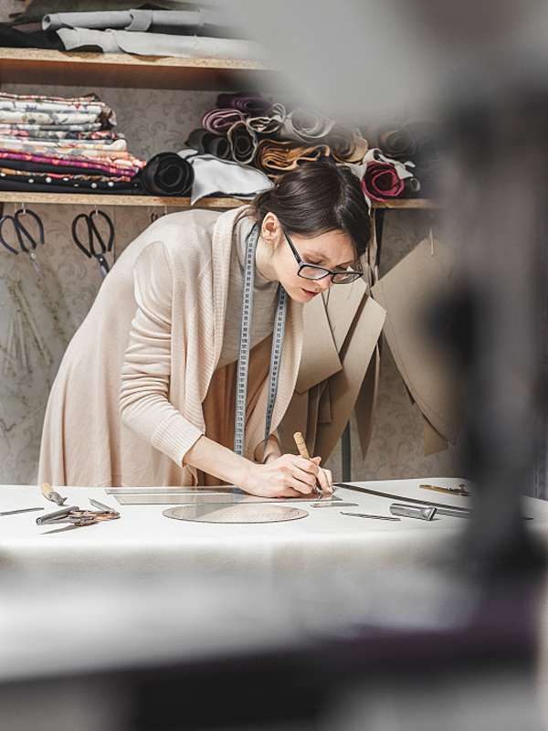 Pattern maker drafting sportswear panels for custom sportswear manufacturer sampling